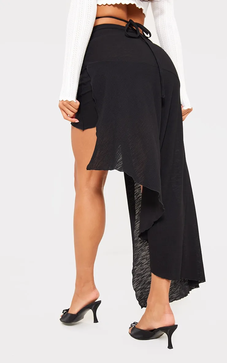 Jupe mi-longue noire asymétrique style portefeuille